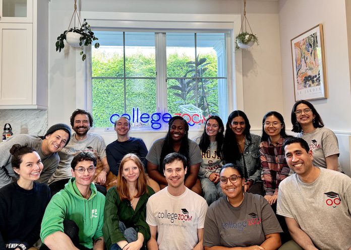 Smiling College Zoom team members in branded shirts at company retreat